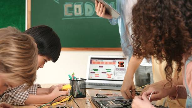 istock Group of diverse student working together while teacher hold tablet. Pedagogy. 2177732066