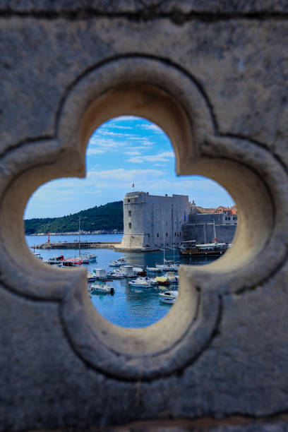istock A view of historic Dubrovnik's harbor through a stone window frame on a sunny day 2177739042
