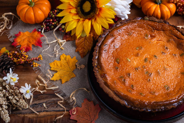 Pumpkin pie on table with autumn decorations. Thanksgiving Day.