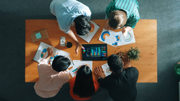istock Top down view of business people analyze data together at meeting. Convocation. 2177743384