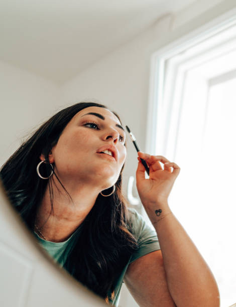 istock woman using make up in the bathroom 2177746805