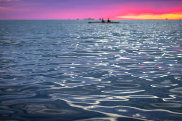 Water texture, sunlight reflecting on sea waves at sunset.