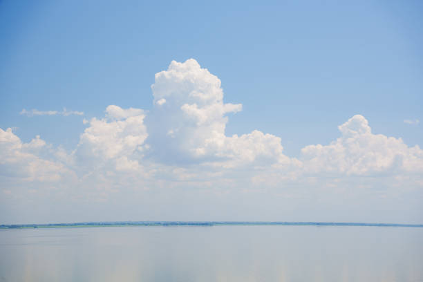 A beautiful blue sky with cumulus clouds over the sea surface. seascape. calm and peace.