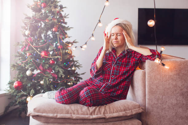 istock Sad woman have headache in front of Christmas tree 2177753607