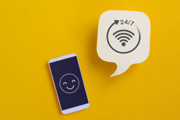 For call center, customer and online service without interruption day and night, real white speech bubble paper cut with 24 hours service sign and mobile phone with smile face icon