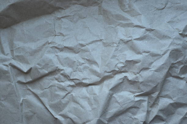 grey crumpled paper texture as background, old kraft paper as background, crumpled packing material texture as background photo above