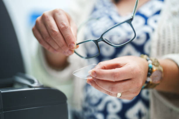 Optician repairing and fixing eye glasses