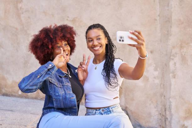 istock Two women are sitting on a ledge 2177760401