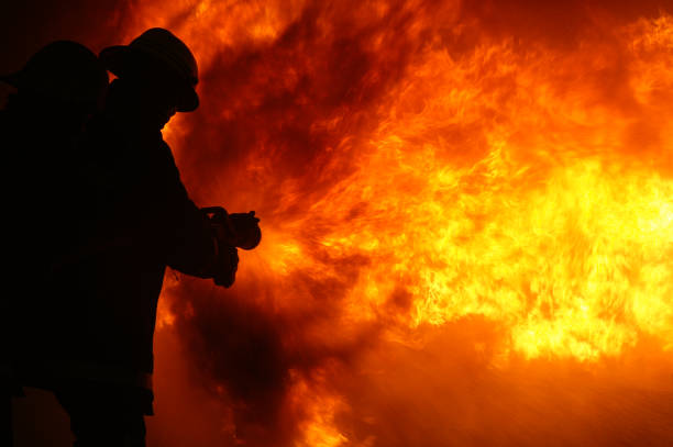 fire fighters fighting fire at Buncefield oil storage facility explosion and fire Hemel Hempstead. UK. disaster zone  December 2005