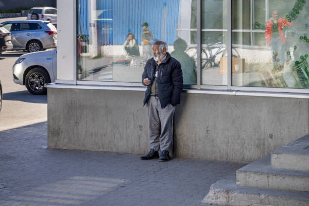 Nuuk, Godthåb, Greenland, Denmark - August 18th 2024:  Mature man waiting outside a shop in the center of Nuuk