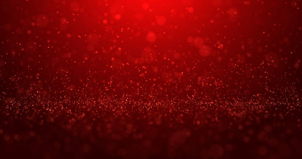 istock Abstract red background of bright glowing glitter particles and beautiful bokeh 2177765808