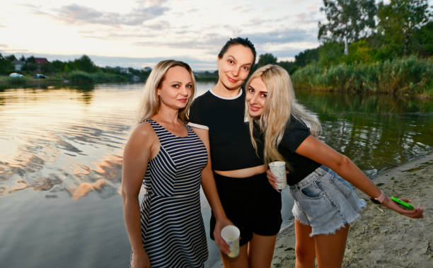 Young families with children relax at the tourist center in the summer, swim in the river and pool.