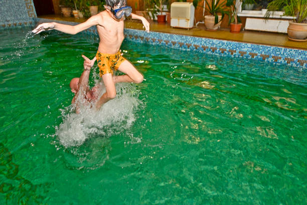 Young families with children relax at the tourist center in the summer, swim in the river and pool.