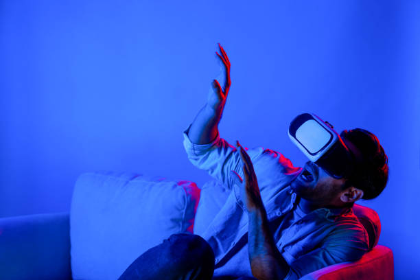 istock Scared person watching at horror movie by using VR goggles at sofa. Deviation. 2177767829
