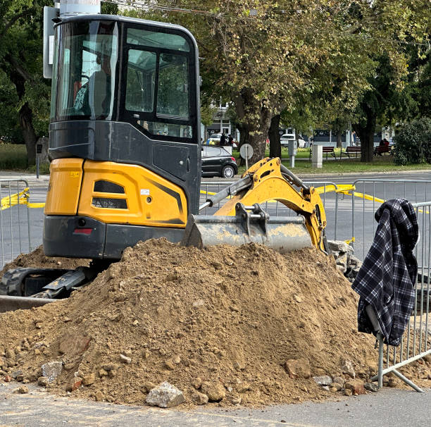 Excavator works at the road construction