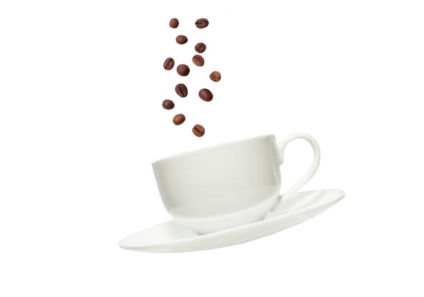 istock White cup for tea or coffee and saucer with flying coffee beans on isolated white background close up 2177770541