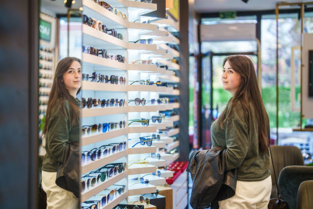 Part of a series in an optic store with opticians and customer.