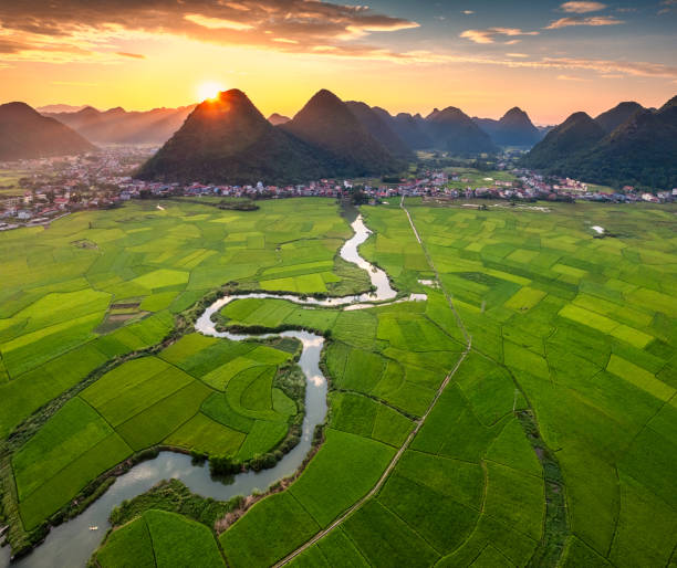 istock Colorful sunset over Bac Son Valley with mountains, lush green fields, winding river and village in Vietnam 2177780496