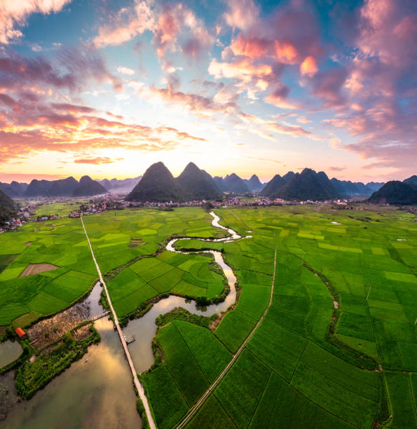 istock Colorful sunset over Bac Son Valley with mountains, lush green fields, winding river and village in Vietnam 2177780505