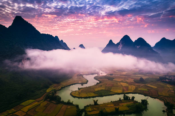 istock Dramatic sunrise over mountain range with foggy on rural village and river flows through in Phong Nam Valley at Cao Bang, Vietnam 2177780506