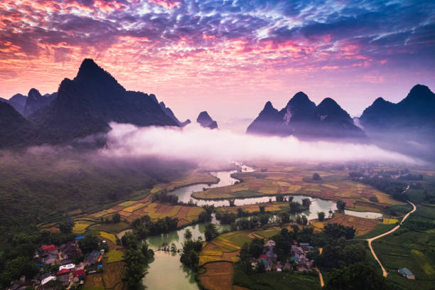 istock Dramatic sunrise over mountain range with foggy on rural village and river flows through in Phong Nam Valley at Cao Bang, Vietnam 2177780509
