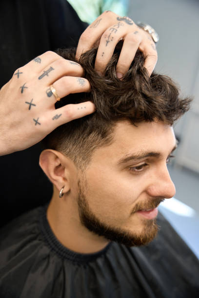 istock Barber use cream to enhance client new hairstyle 2177784861