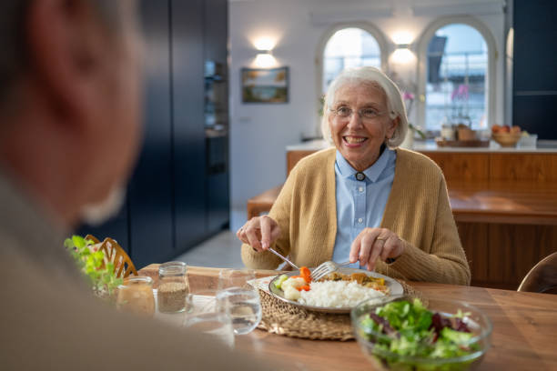 istock Elderly Couple Enjoys Cozy Dinner at Home 2177789896