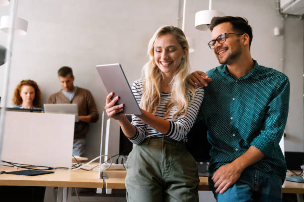 Group of young multi-ethnic startup business team collaborating on project in modern office