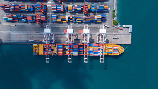 istock crane loading cargo container from truck to container ship in the international terminal logistic sea port concept freight shipping by ship. industry transportaion 2177790332