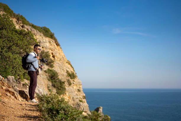 istock Tourist on cliff looking at sea 2177791673