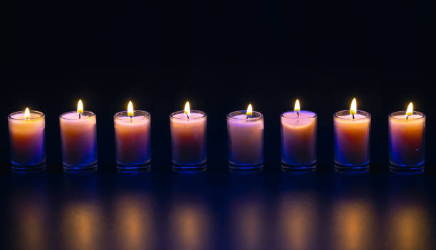 istock Burning candle on black background with backlight. Memorial Day. 2177791818