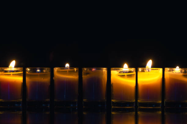 Burning candle on black background with backlight. . Memorial Day. High quality photo