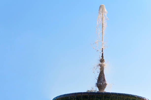 istock Fountain with shining clear liquid on a sky with clouds background 2177800889