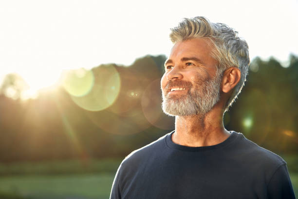 istock A Reflective Man with a Pleasant Smile in the Warm Natural Light During a Beautiful Sunset 2177801689