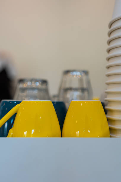 Red and yellow coffee mug on the table.