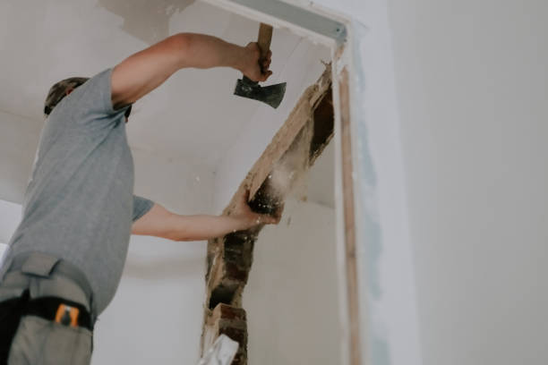 istock A young Caucasian male builder clears a doorway using a crowbar. 2177804551