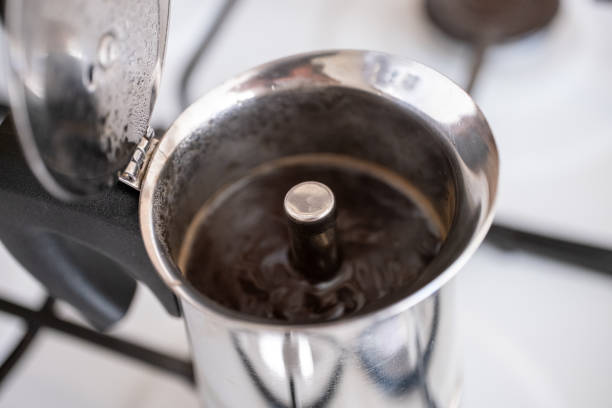 istock Filling ground coffee into moka pot on brown background 2177807130