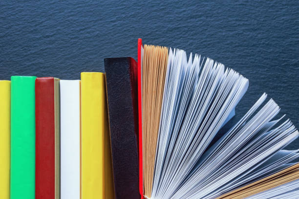istock Different colorful books against black background. Copy space 2177807625