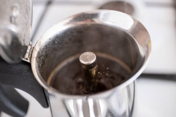 istock Filling ground coffee into moka pot on brown background 2177808045