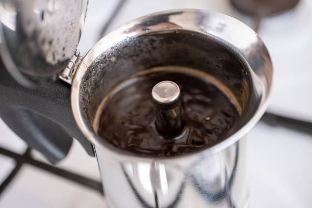 istock Filling ground coffee into moka pot on brown background 2177808120
