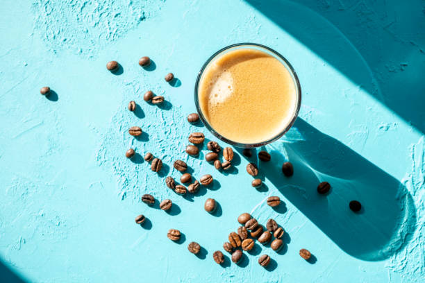 istock coffee beans on brown background and a cup of espresso coffee 2177808203