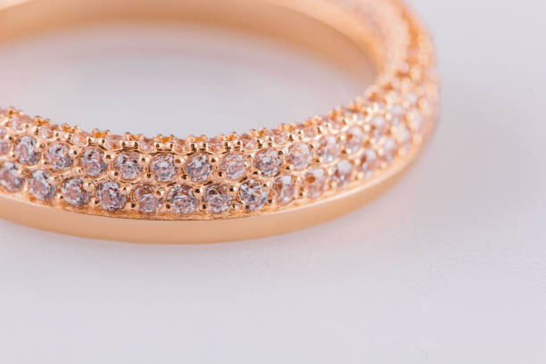 istock An elegant gold ring with round-cut diamonds in a gold setting. A ring on a white background. Wedding ring close-up. 2177808325