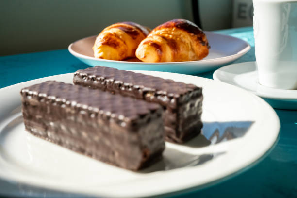 croissant on a pink plate with a cup of espresso coffee in slow motion