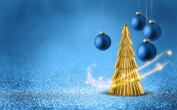Gold Christmas tree and hanging bauble on shiny glitter blue background with bokeh light. Festive winter holiday decoration and ornament.