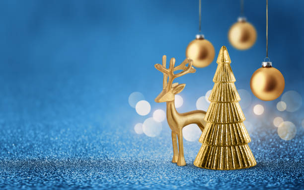 istock Gold deer, Christmas tree and bauble on shiny glitter blue background with bokeh light. Festive winter holiday decoration and ornament. 2177815870