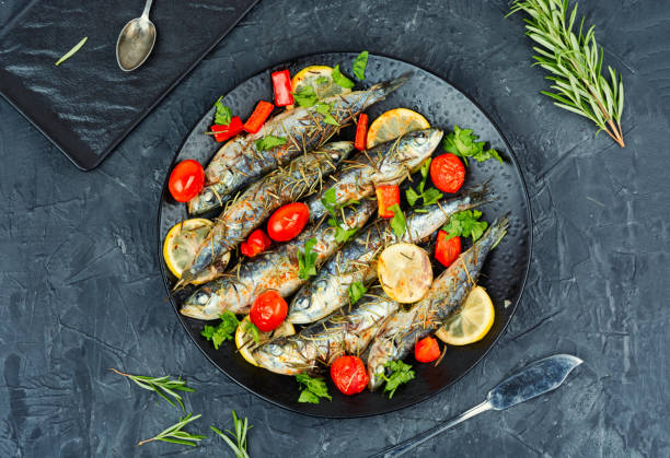istock Grilled sardines on a plate with lemon. 2177816412