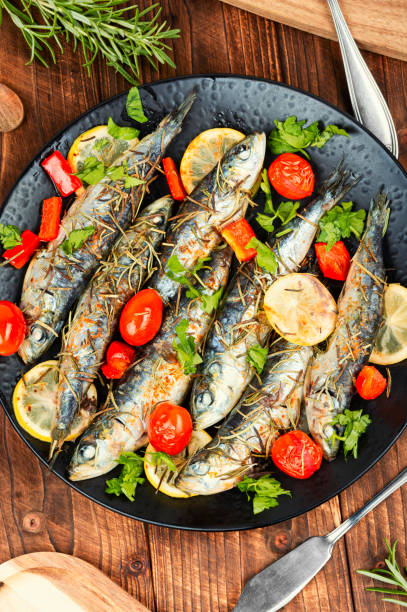 istock Grilled sardines on a plate with lemon. 2177816474