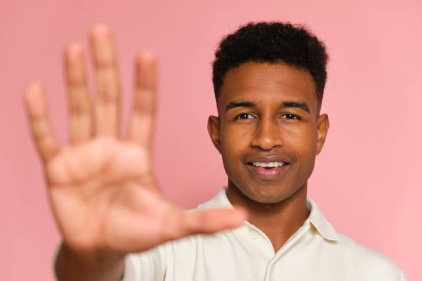 istock Young man making stop gesture with hand on pink background 2177819273