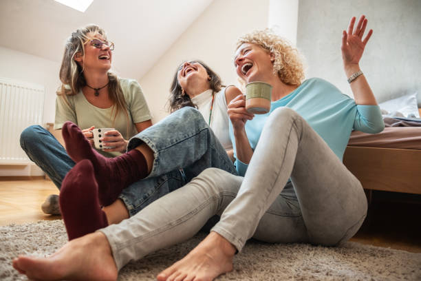 A modern mother enjoys a coffee while spending time with her two daughters.