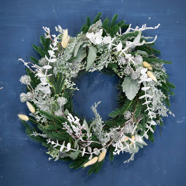 Christmas wreath of white needles on a blue background